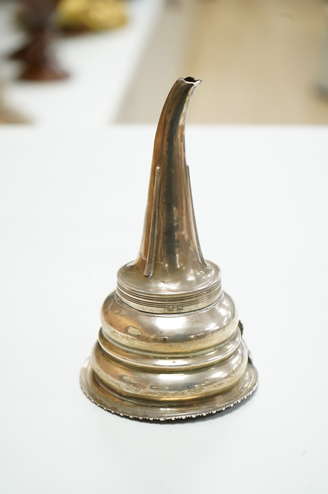 A George III silver wine funnel, with shell thumbpiece, marks rubbed, 14.5cm.
